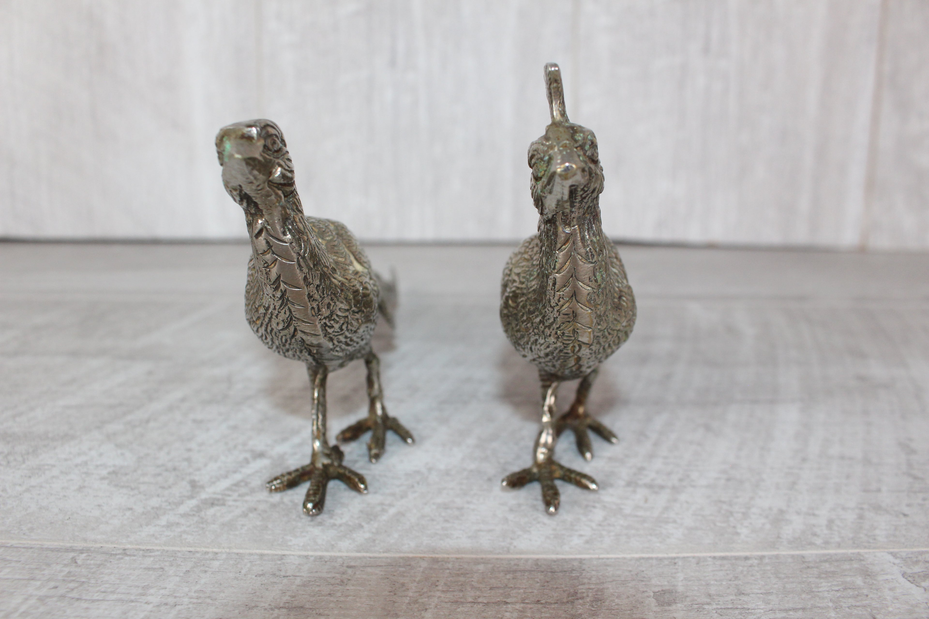 A Pair of Silver Plated Peacocks - Male and Female 10" length