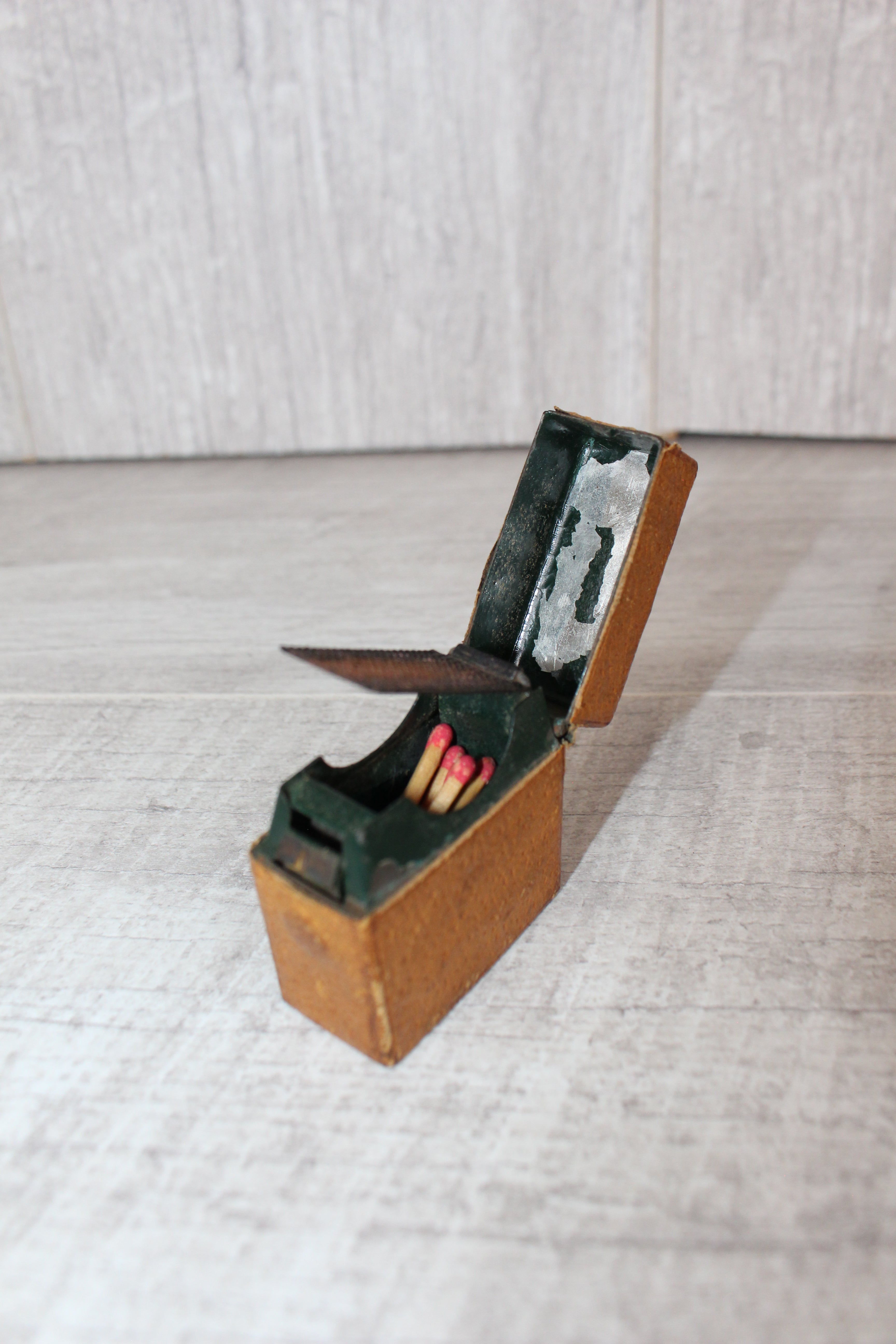 Edwardian metal leatherette covered vesta case, original matches