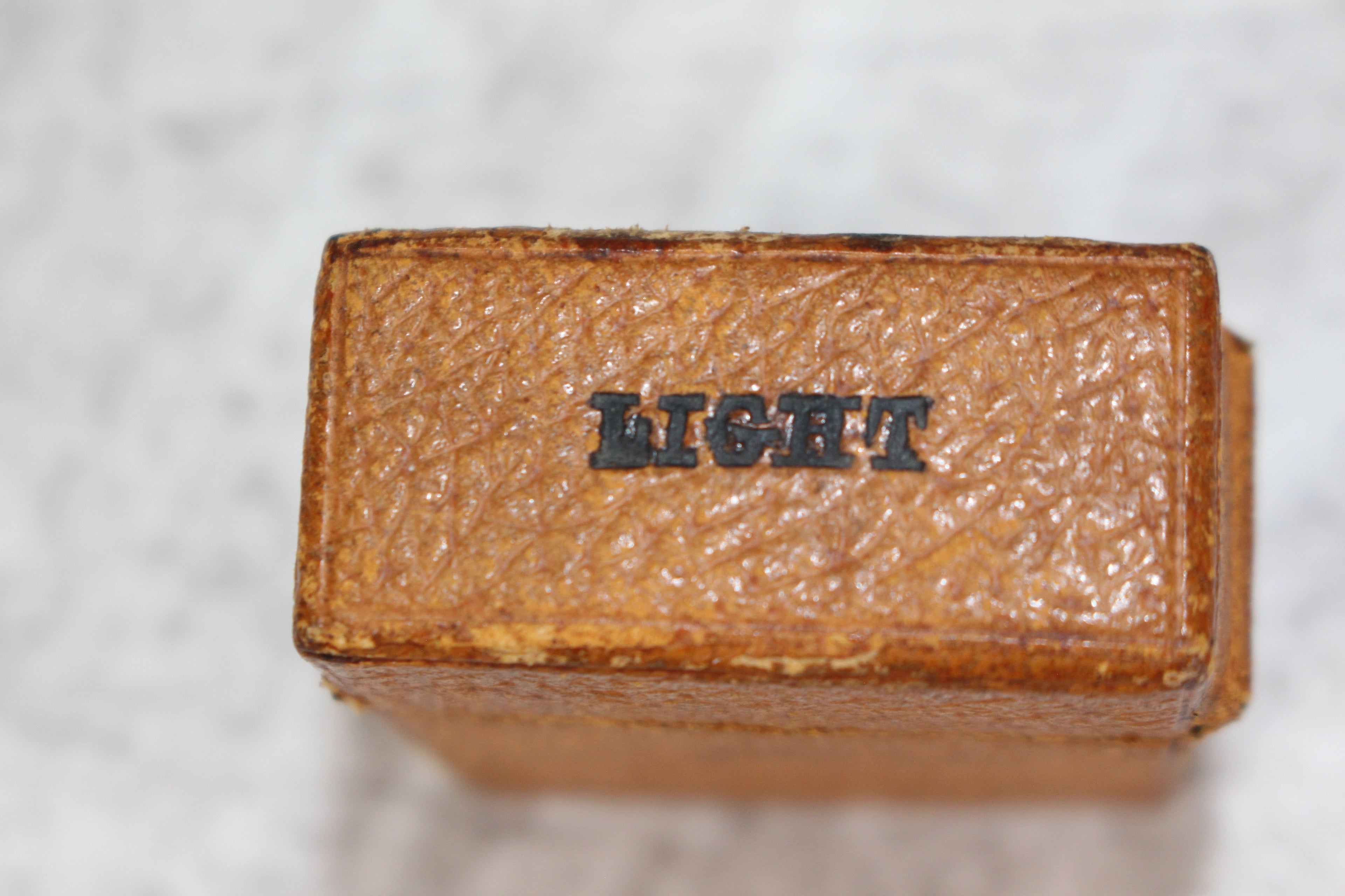 Edwardian metal leatherette covered vesta case, original matches