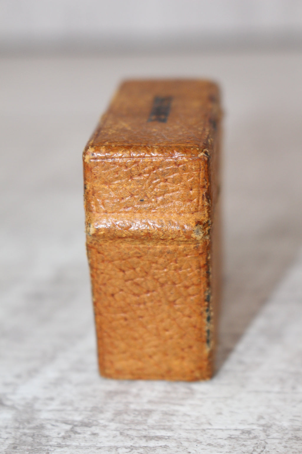 Edwardian metal leatherette covered vesta case, original matches