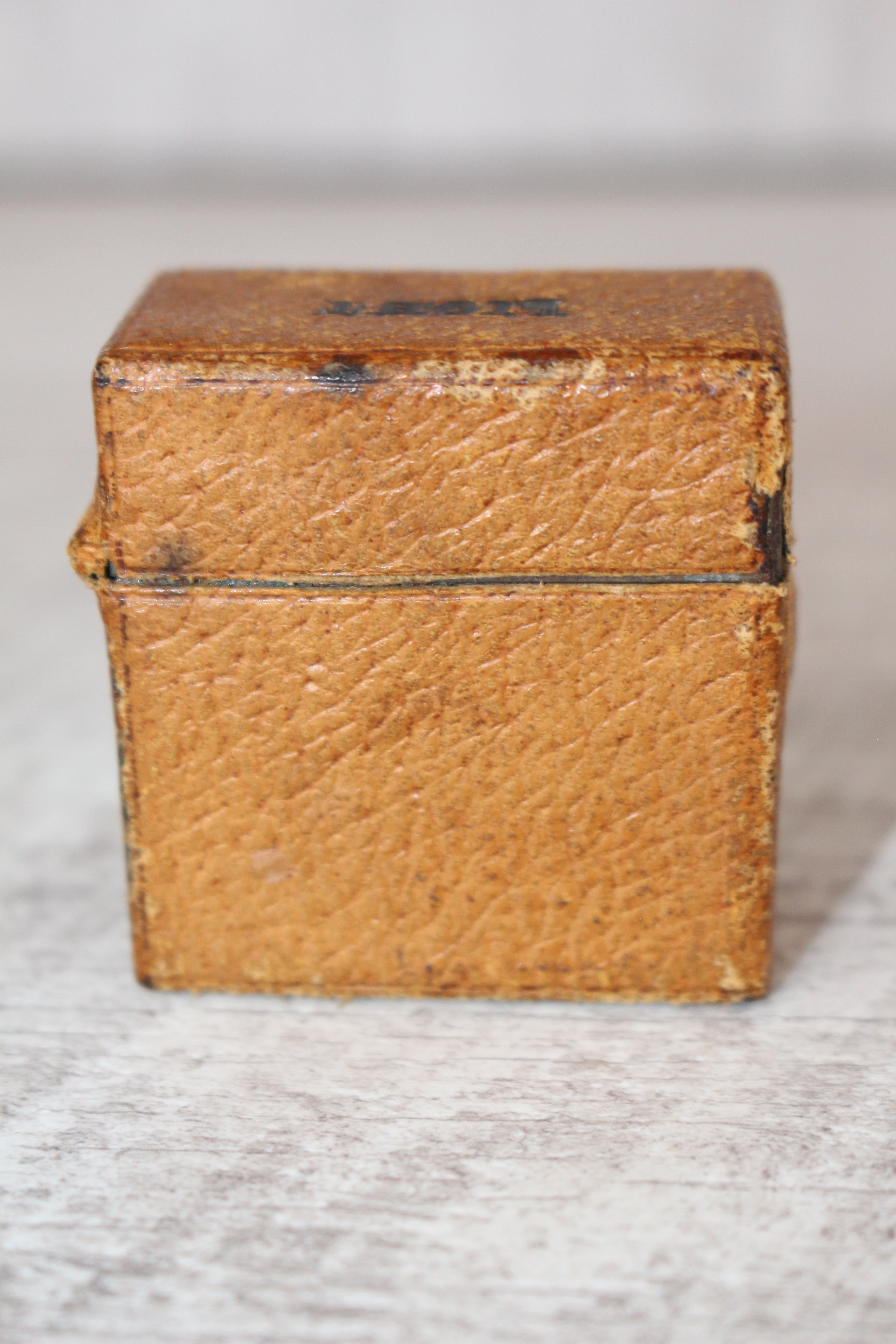 Edwardian metal leatherette covered vesta case, original matches