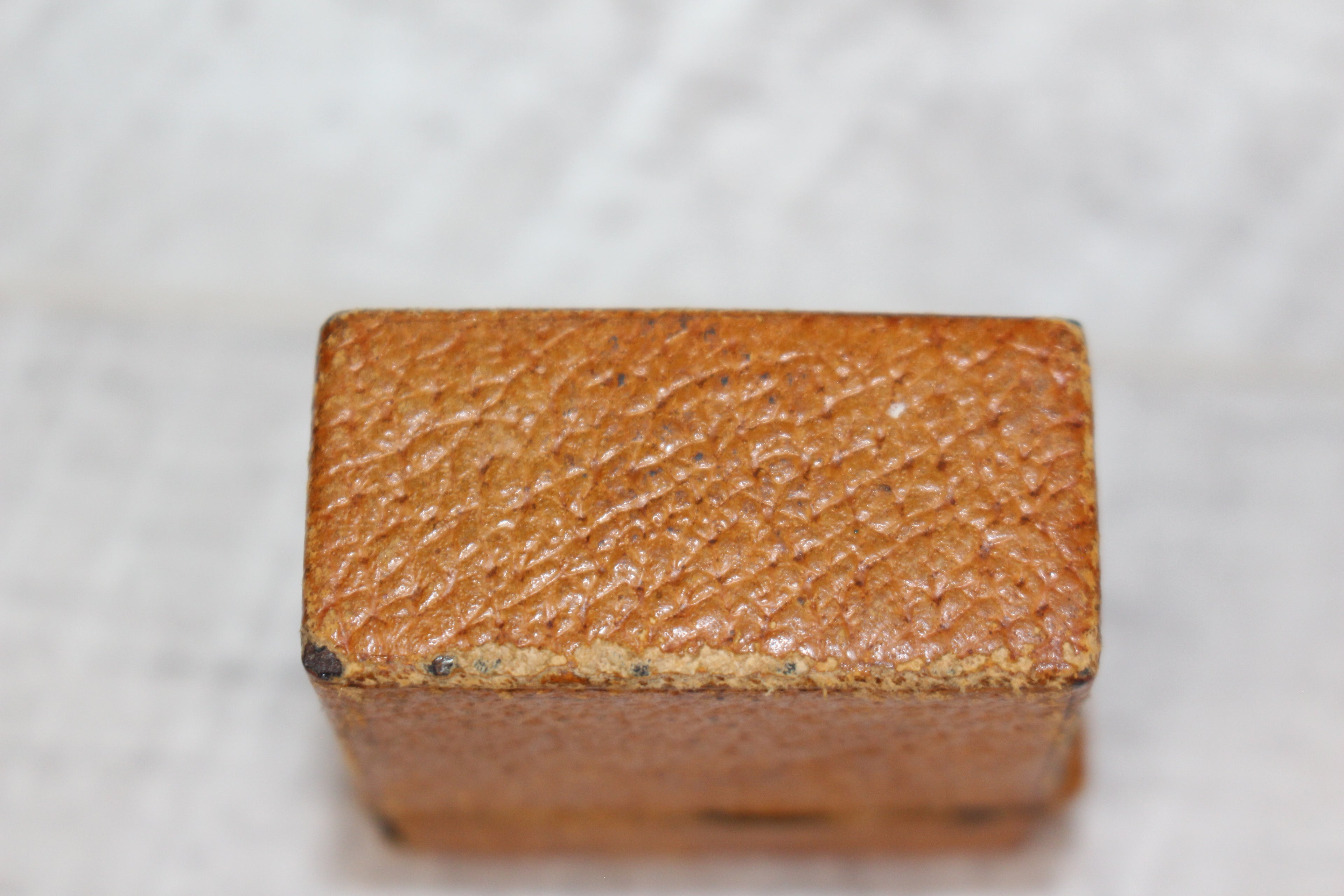 Edwardian metal leatherette covered vesta case, original matches